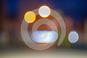 Bright colorful bokeh circles at night. Blurred city lights background