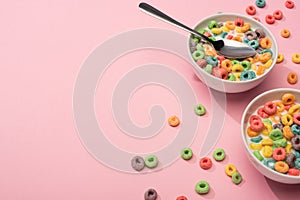 Bright colorful breakfast cereal with milk in bowls with spoon