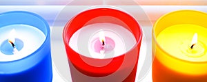 Bright colorful candles. Scented colorful candles with lighted wicks