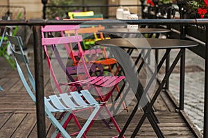 Bright colorful chairs on the terrace of a cafe. Street cafe. Street food. Summer cafe.