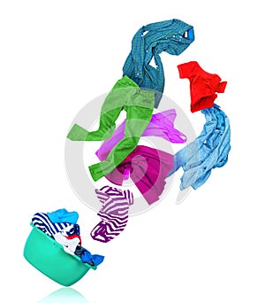 Bright colorful clothes flying out from wash bowl on white