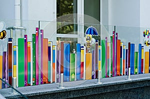 Bright colorful drawing on a glass fence at the entrance to the city children`s library