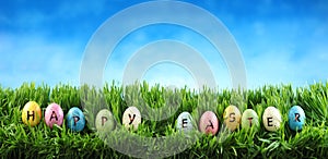 Bright colorful Easter eggs on green grass