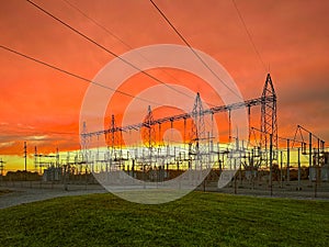 Bright, colorful evening clouds reflect setting sun over a Electric Substation