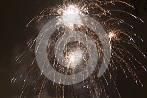 Bright colorful fireworks on new years eve in Ostrava, Czech republic against cloudy sky