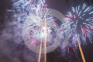 Bright colorful fireworks on new years eve in Ostrava, Czech republic against cloudy sky