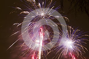 Bright colorful fireworks on new years eve in Ostrava, Czech republic against cloudy sky