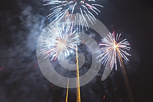 Bright colorful fireworks on new years eve in Ostrava, Czech republic against cloudy sky