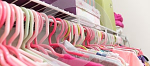 Bright and colorful neatly organized girl`s closet.