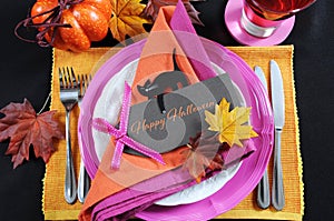 Bright and colorful pink, orange and black modern Happy Halloween table place setting photo