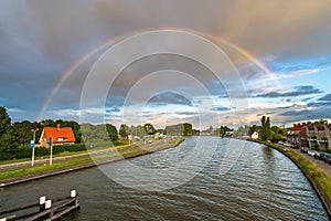 Bright colorful rainbow over a river