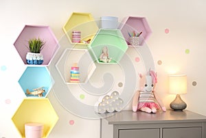 Bright colorful shelves on light wall in room. Interior design