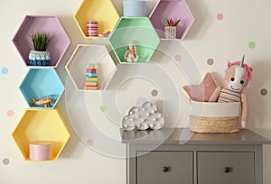 Bright colorful shelves on wall in room. Interior design