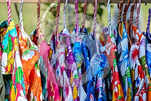 Bright colorful shirt for summer on wooden hangers