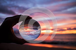 Bright Colorful Sunset over Ocean Captured in Glass Ball