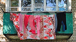 Bright colorful underwear dries after washing on the balcony