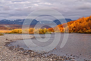 The bright colors of autumn in the mountains and on the river.