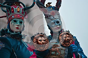 The bright colors of the costumes and masks of the carnival photo