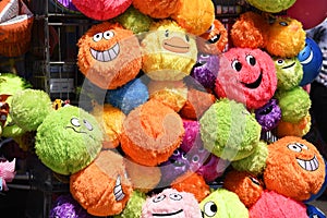 Bright, colourful, colorful, smiling smiley plushy toys on a seaside souvenir stall shop. Southend on Sea