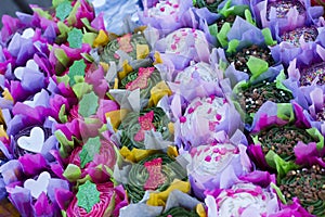 Bright colourful cupcakes in rows