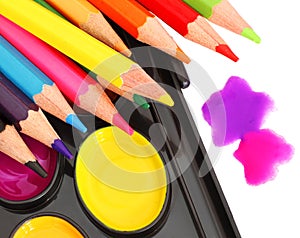 Bright colourful paint and pencils