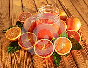 Bright composition with red oranges and fruit juice of fresh blood oranges