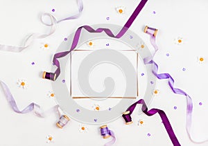 Bright composition with silk ribbons, chamomile, sequins and crystal on a white background. Space for a greeting text. Photos for