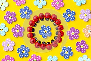 Bright creative background with decorative wooden buttons and ladybugs