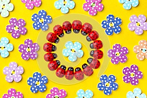 Bright creative background with decorative wooden buttons and ladybugs