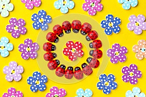 Bright creative background with decorative wooden buttons and ladybugs