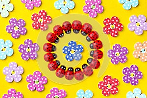 Bright creative background with decorative wooden buttons and ladybugs