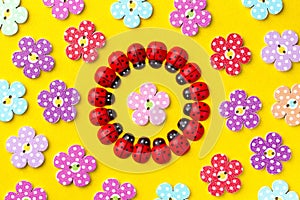 Bright creative background with decorative wooden buttons and ladybugs