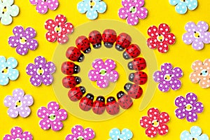 Bright creative background with decorative wooden buttons and ladybugs