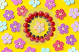 Bright creative background with decorative wooden buttons and ladybugs