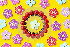 Bright creative background with decorative wooden buttons and ladybugs