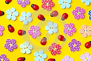 Bright creative background with decorative wooden buttons and ladybugs