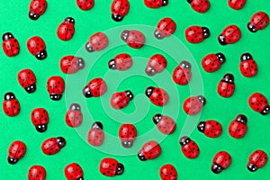 Bright creative colored background with decorative wooden ladybugs