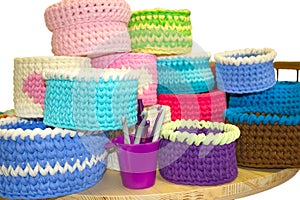 Bright crochet colorful boxes and crochet hooks on the wooden tabl isolated on white. Thick ribbon cotton yarn.