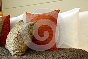 Bright cushions against white pillows. photo