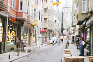 Bright defocused blurred background with unrecognizable people on the sity street. Abstract image of crowd of people in