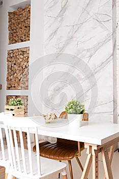 Bright dining room with big white wooden table