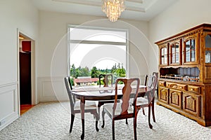 Bright dining room with carved wood cabinet