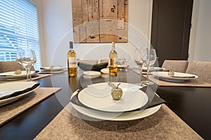 Bright dining room table set for dinnert