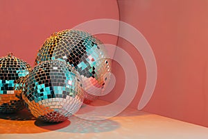 Bright disco balls on color background, above view. Space for text