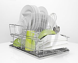 Bright dishes drying on metal dish rack photo