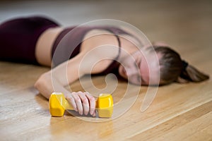 Bright dumbbell, gym and tired athlete