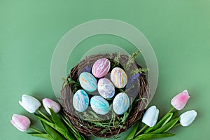 Bright early colored easter eggs green background