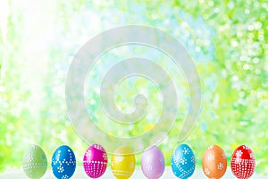 Bright early colored easter eggs on a sunny spring background