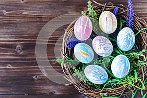 Bright early colored easter eggs wooden background