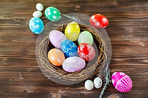 Bright early colored easter eggs wooden background